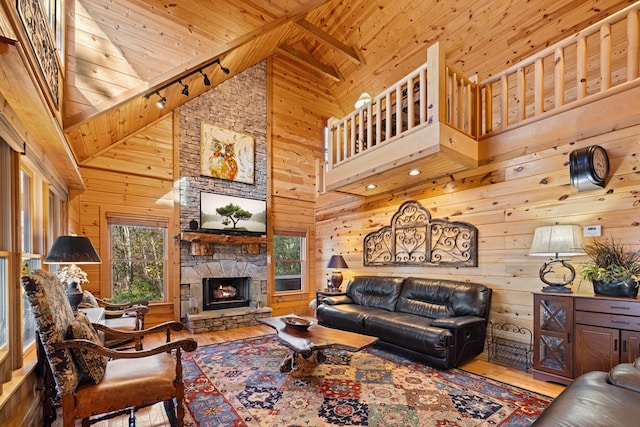 living room featuring hardwood / wood-style floors, wood walls, wood ceiling, and high vaulted ceiling