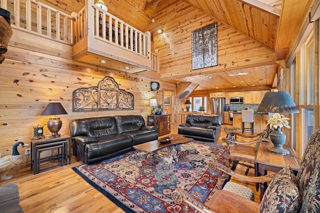 living room featuring wooden walls, high vaulted ceiling, wood ceiling, and light wood-type flooring