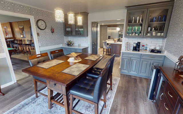 dining space with wood-type flooring and ornamental molding