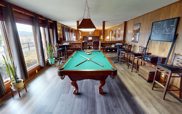 rec room featuring wooden walls, pool table, and light hardwood / wood-style floors