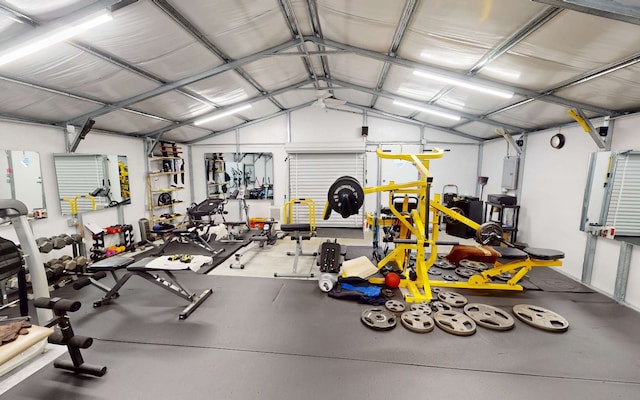 workout area featuring lofted ceiling and electric panel