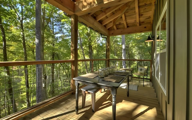 sunroom / solarium with vaulted ceiling and a healthy amount of sunlight