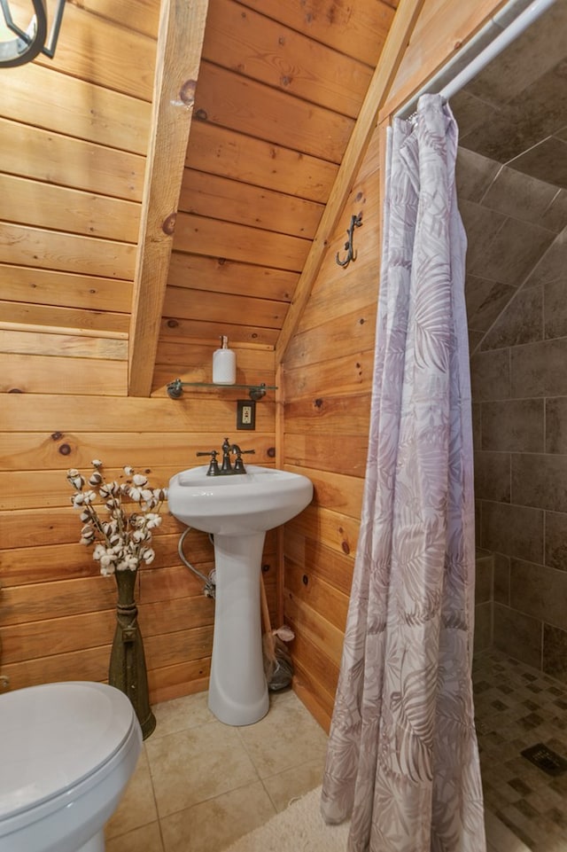 bathroom with vaulted ceiling, a shower stall, tile patterned flooring, wooden ceiling, and wooden walls