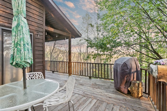 wooden deck featuring outdoor dining area and area for grilling
