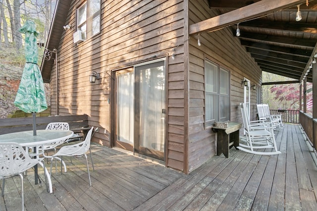 deck featuring outdoor dining area and cooling unit
