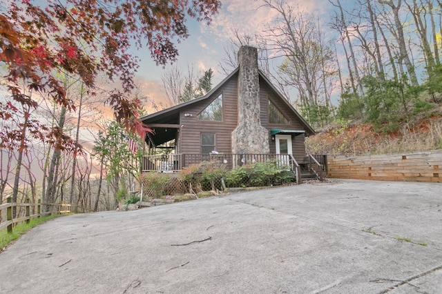 property exterior at dusk with a chimney
