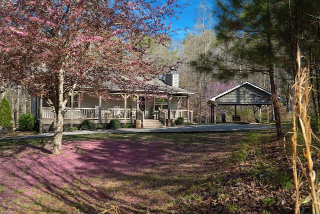 exterior space with covered porch and a chimney