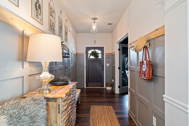 foyer entrance with dark wood-style floors and visible vents