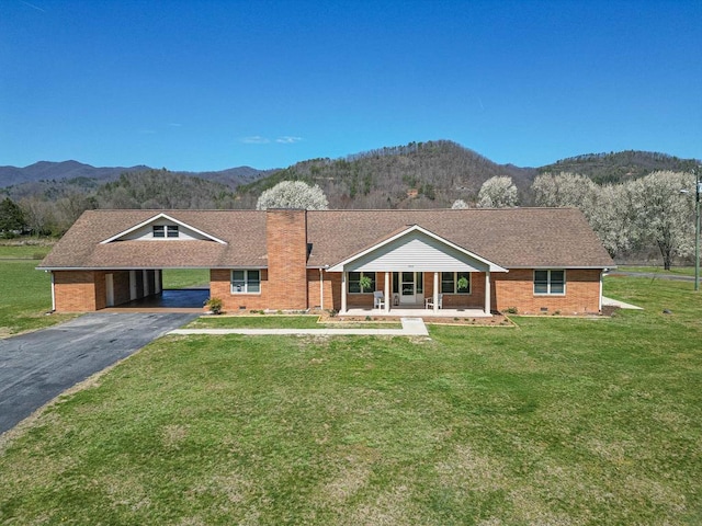 2915 Airport Rd, Marble, NC 28905 - view of front facade with brick siding, a front yard, driveway, and a mountain view