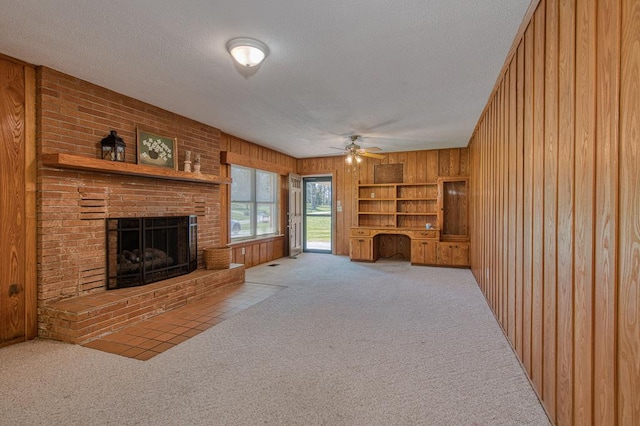 2915 Airport Rd, Marble, NC 28905 - living room featuring carpet floors, a textured ceiling, wood walls, and a ceiling fan