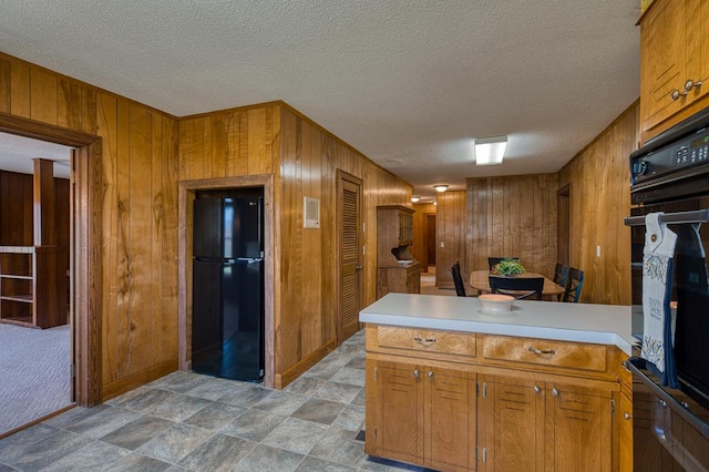 2915 Airport Rd, Marble, NC 28905 - kitchen featuring brown cabinets, black appliances, light countertops, and a peninsula