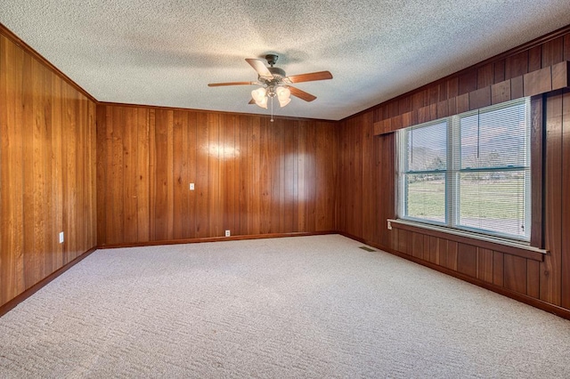2915 Airport Rd, Marble, NC 28905 - carpeted empty room featuring visible vents, wooden walls, and ceiling fan
