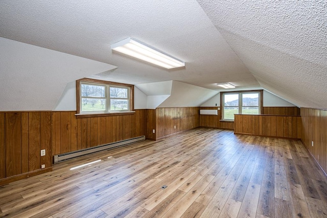 2915 Airport Rd, Marble, NC 28905 - bonus room with wood-type flooring, wood walls, a textured ceiling, and baseboard heating