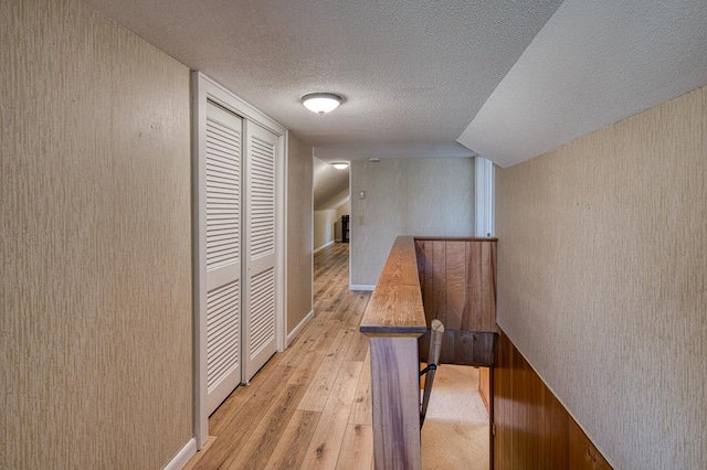 2915 Airport Rd, Marble, NC 28905 - corridor featuring an upstairs landing, a textured ceiling, and light wood-type flooring