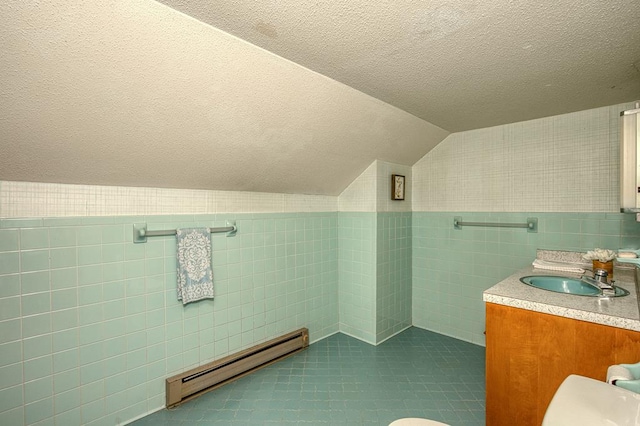 2915 Airport Rd, Marble, NC 28905 - bathroom featuring vaulted ceiling, a textured ceiling, baseboard heating, wallpapered walls, and tile walls