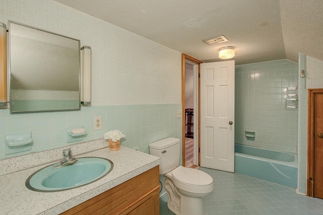 2915 Airport Rd, Marble, NC 28905 - full bath featuring toilet, vanity, a textured ceiling, tile patterned flooring, and tile walls
