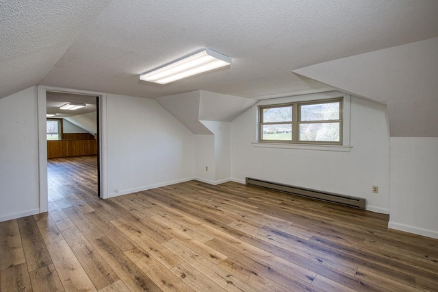 2915 Airport Rd, Marble, NC 28905 - bonus room featuring a textured ceiling, a wealth of natural light, baseboard heating, and hardwood / wood-style flooring