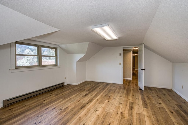 2915 Airport Rd, Marble, NC 28905 - additional living space with a textured ceiling, a baseboard heating unit, and light wood-type flooring