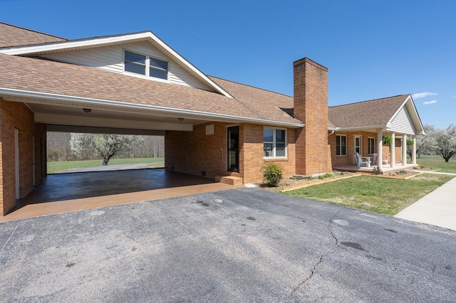 2915 Airport Rd, Marble, NC 28905 - view of front facade featuring aphalt driveway, a chimney, a front yard, roof with shingles, and a porch