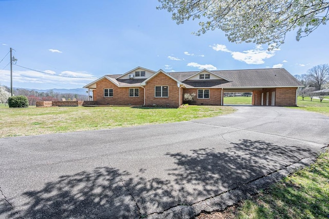 2915 Airport Rd, Marble, NC 28905 - view of front of home with brick siding, a front yard, driveway, and a carport