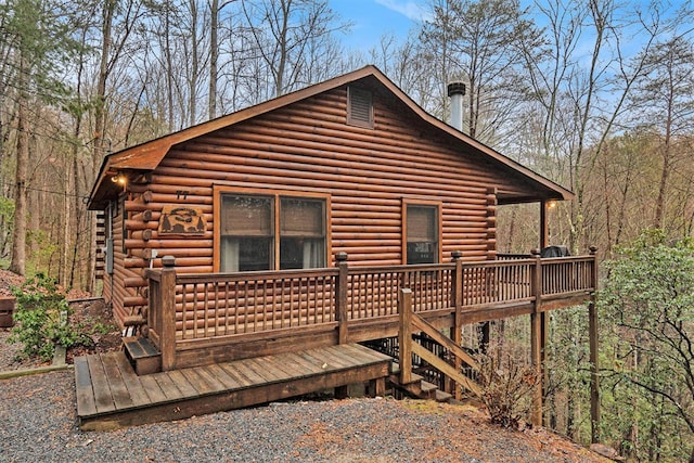 rear view of property featuring a wooden deck