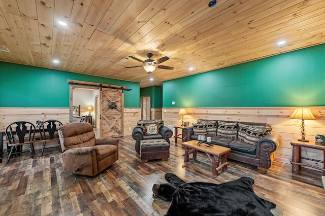 30 The Forest Rd, Blue Ridge, GA 30513 - living room with a barn door, a wainscoted wall, hardwood / wood-style floors, wooden ceiling, and a ceiling fan