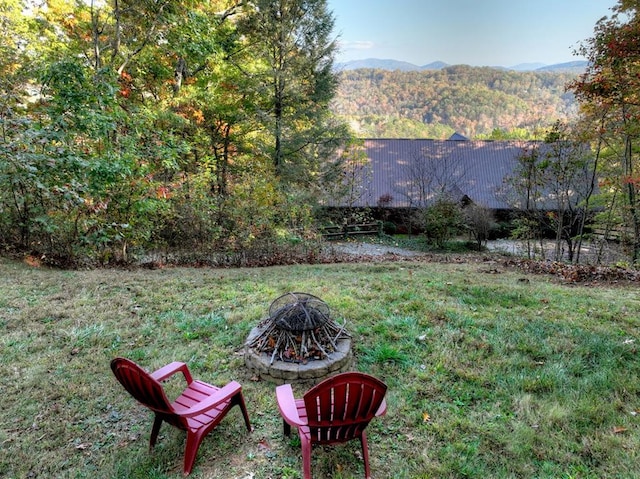 view of yard featuring a fire pit and a mountain view