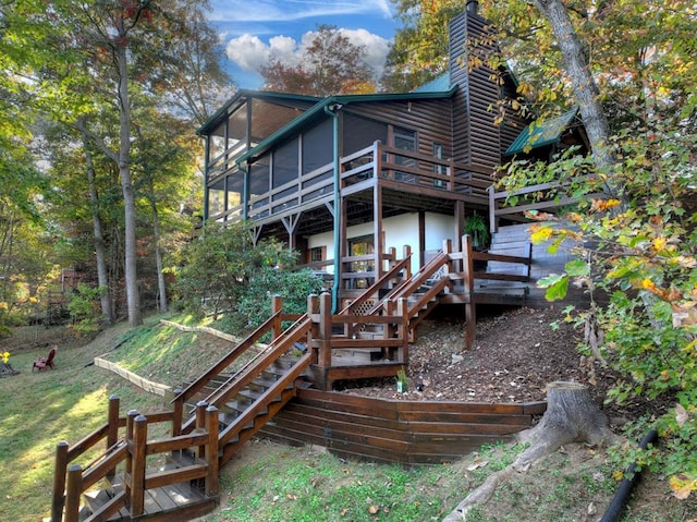 back of house featuring a deck