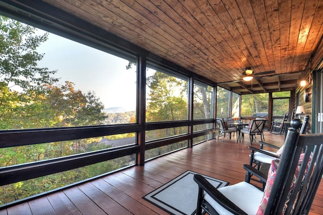 sunroom with wooden ceiling and ceiling fan