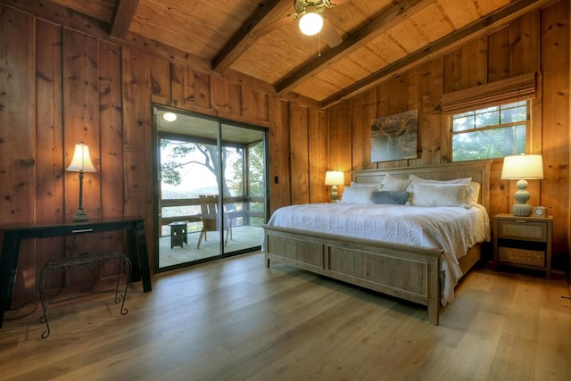 bedroom featuring access to exterior, lofted ceiling with beams, light hardwood / wood-style floors, and multiple windows