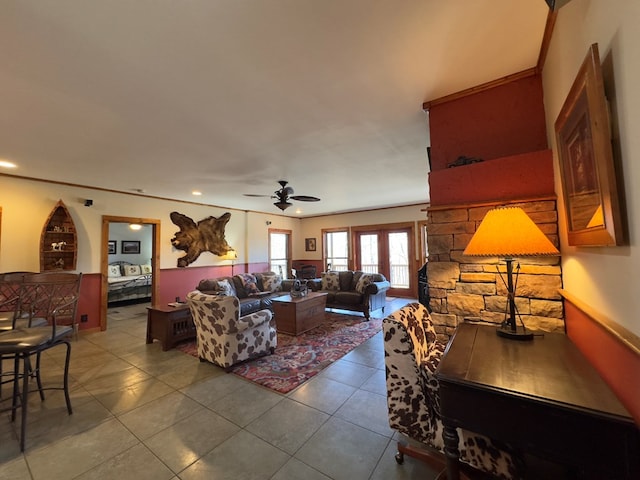 living room featuring crown molding, tile patterned floors, and ceiling fan