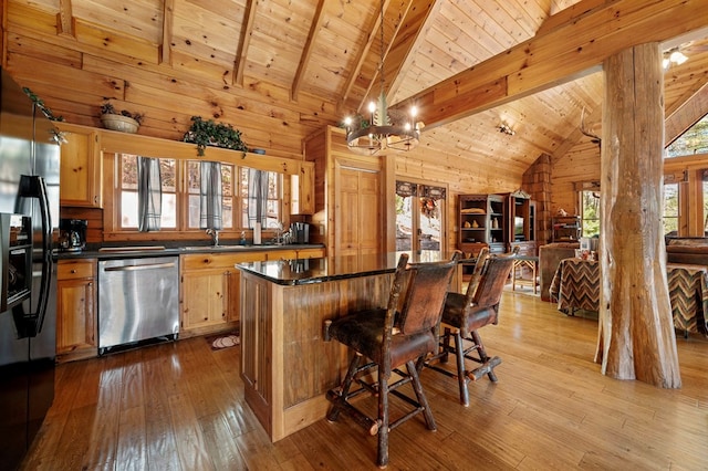 kitchen featuring stainless steel dishwasher, dark countertops, black fridge with ice dispenser, and wood ceiling