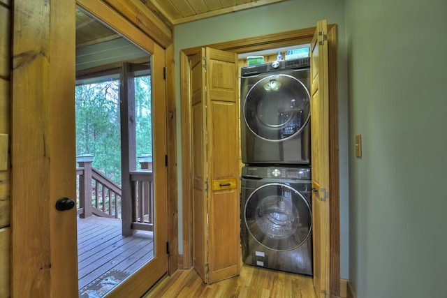 washroom featuring light wood-type flooring and stacked washer / drying machine