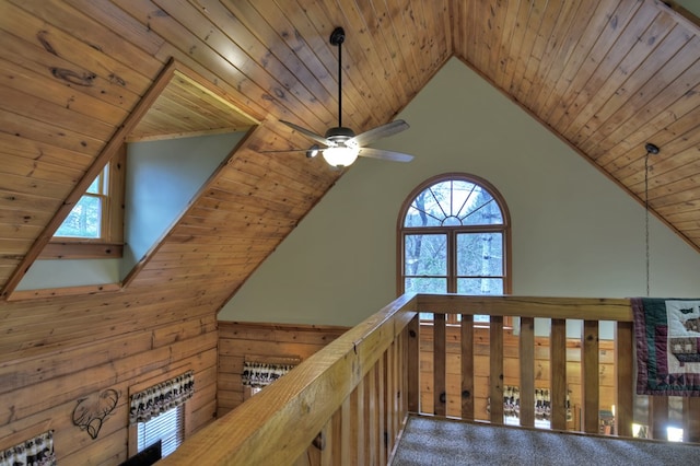 hall featuring high vaulted ceiling and wooden ceiling