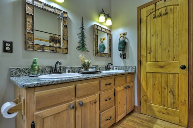 bathroom with vanity and hardwood / wood-style flooring