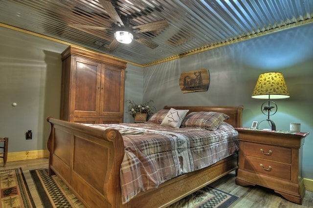 bedroom with ceiling fan and hardwood / wood-style flooring