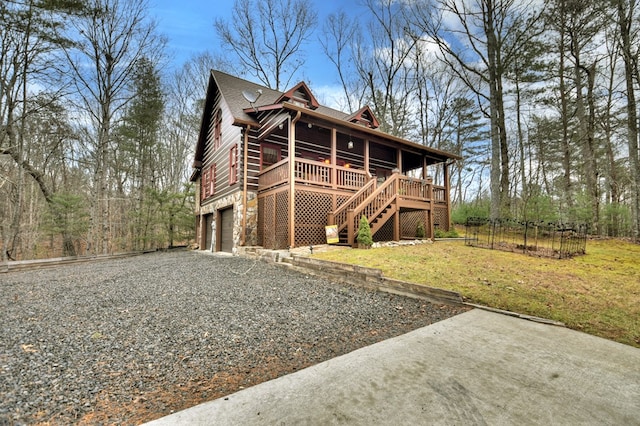 back of house featuring a garage and a lawn