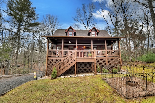 view of front of property featuring a front yard and a wooden deck