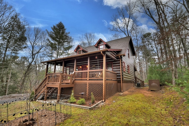 rear view of house with central air condition unit and a wooden deck