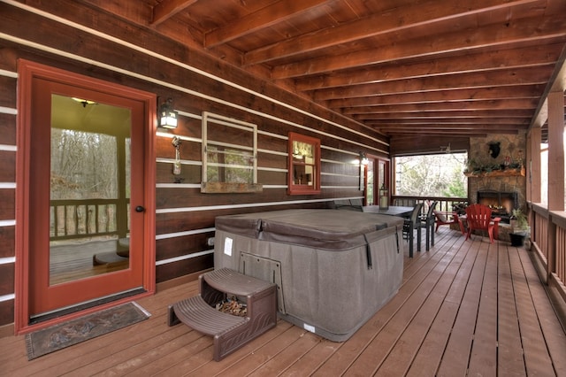 deck with a fireplace and a porch