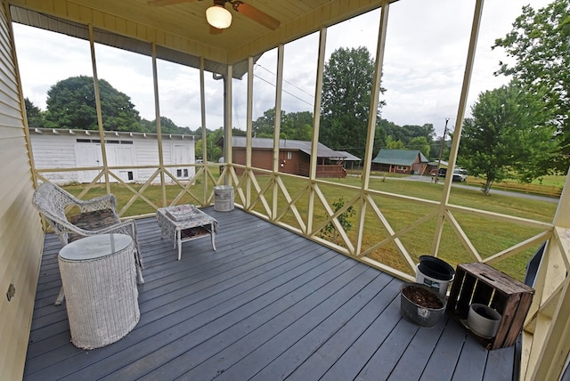 unfurnished sunroom featuring a wealth of natural light and ceiling fan