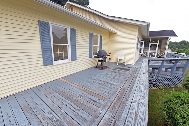 deck featuring area for grilling and a sunroom