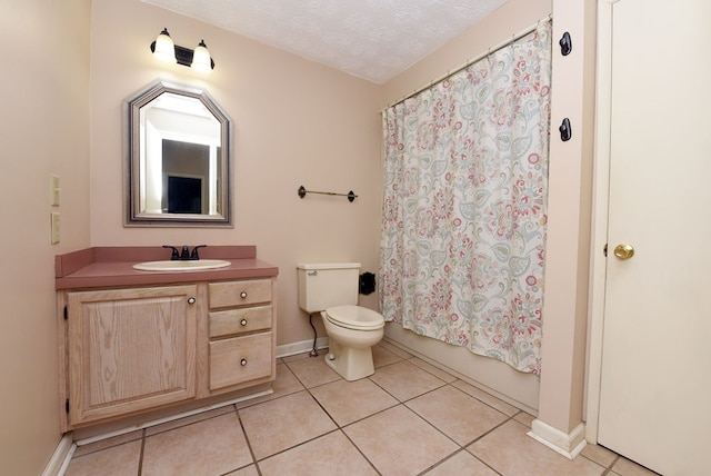 full bathroom featuring tile patterned flooring, vanity, toilet, and a textured ceiling