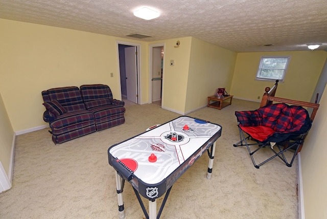 playroom with carpet and a textured ceiling