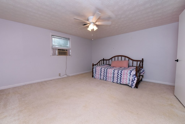 bedroom featuring cooling unit, light colored carpet, ceiling fan, and a textured ceiling