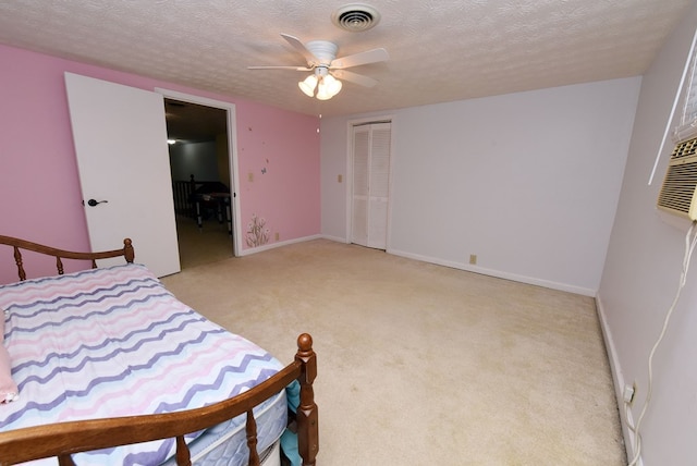 bedroom with ceiling fan, a closet, light carpet, and a textured ceiling