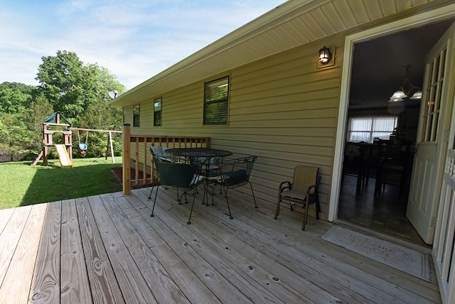 deck with a lawn and a playground