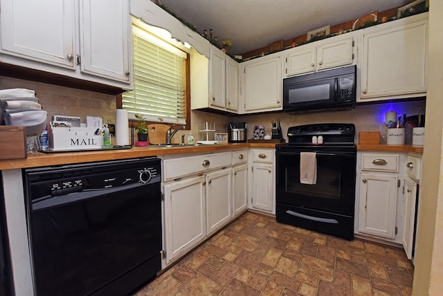 kitchen featuring wood counters, black appliances, white cabinets, sink, and a textured ceiling