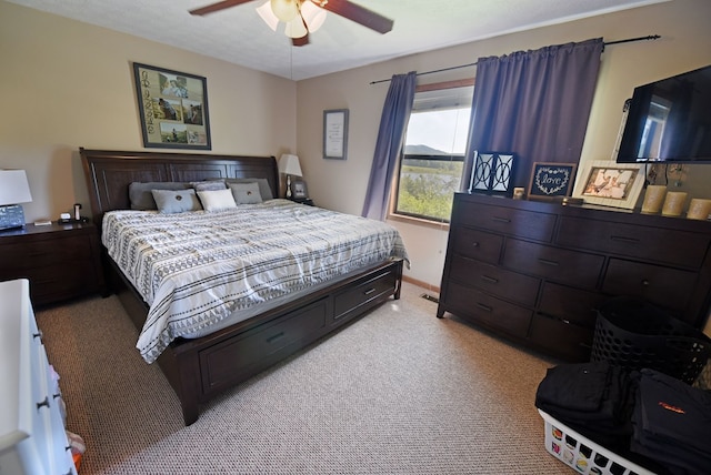 carpeted bedroom with ceiling fan and a textured ceiling