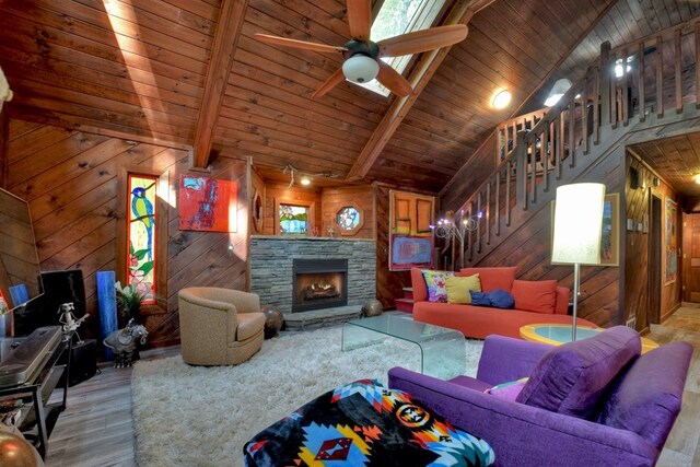 112 Songbird, Blue Ridge, GA 30513 - living area featuring wood finished floors, stairway, wood walls, wooden ceiling with exposed beams, and a stone fireplace